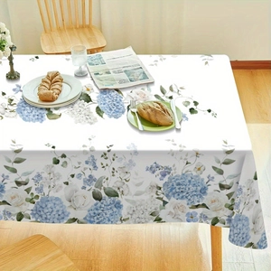 Detail of floral rectangular tablecloth featuring blue hydrangea and white rose patterns