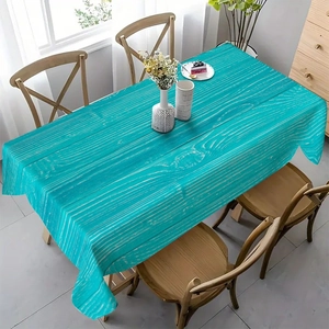 Close-up of rectangular teal floral tablecloth with wood grain texture for home dining