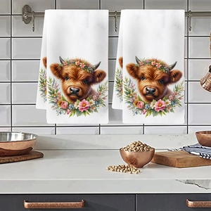 Close-up of floral highland cow print on soft white kitchen towel in a modern setting