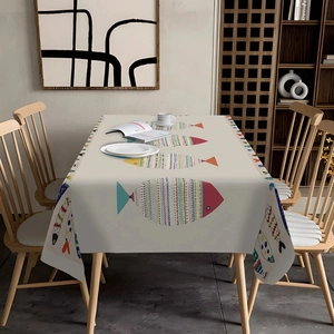 Detail of bohemian colorful fish pattern on a beige rectangular cotton tablecloth