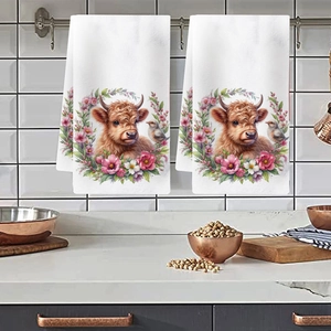 Kitchen hanging towels with floral Highland cow prints on white textured fabric detail