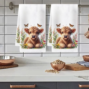 Hanging kitchen towels featuring floral highland cow print on a metal rack setup