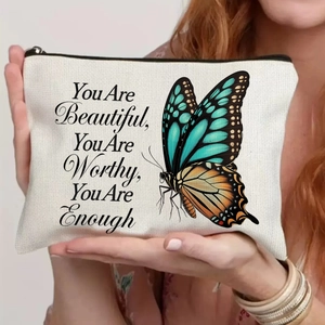 Detail of canvas makeup bag featuring blue butterflies and inspiring quote text