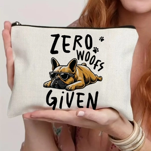 Close-up of canvas makeup bag with Zero Woofs Given French Bulldog print held by model