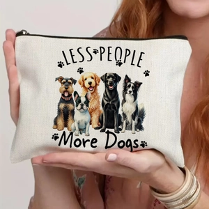 Close-up of white canvas makeup bag featuring cute dog prints and Less People More Dogs text