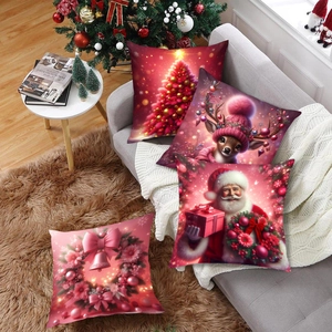 Set of four pink Christmas pillow covers featuring Santa and reindeer on a gray sofa
