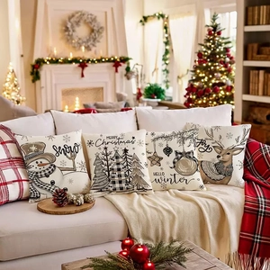 Set of 4 vintage Christmas pillow covers with snowman and reindeer on a sofa