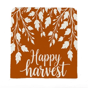 Close-up of linen fabric texture featuring Happy Harvest text and maple branch pattern