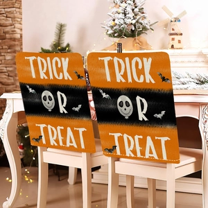 Detail of Halloween chair covers featuring pumpkins and Trick or Treat text for dining decor