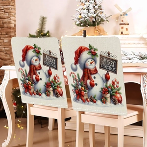 Detailed view of linen-textured Christmas chair covers with snowman patterns and Merry Christmas signs