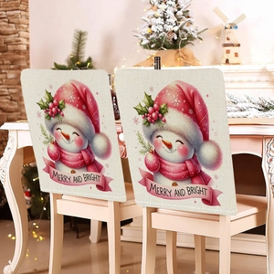 Detail of Christmas snowman chair covers with Merry and Bright text on beige linen fabric