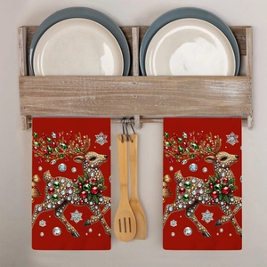 Close-up of red Christmas reindeer towels with jewel and bell decor hanging in a kitchen
