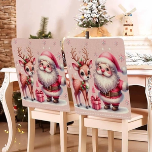 Set of two pink Christmas chair covers featuring Santa and reindeer on white wooden chairs