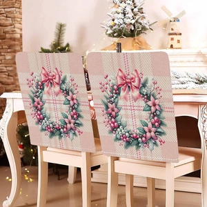 Pink Christmas chair covers with plaid patterns and floral wreaths for festive dining decor
