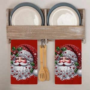 Close-up of red Christmas Santa Claus kitchen towels hanging on a rustic wooden rack