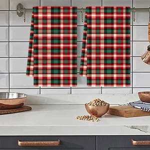 Kitchen towel set with classic red, green, and white plaid design hanging on a rack