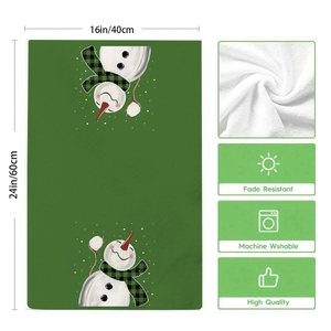 Detail of green Christmas snowman kitchen towel showing 40x60cm size and soft fabric texture