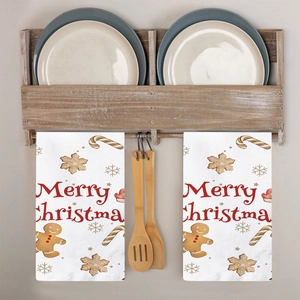 Set of two white Christmas kitchen towels with Merry Christmas text and gingerbread man
