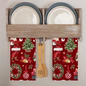 Close-up of festive red Christmas tea towels with Santa and tree patterns in a kitchen