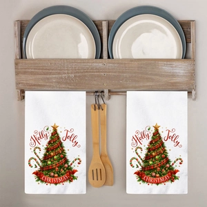 Christmas tree and Holly Jolly print on white cotton kitchen towels set hanging on a rack