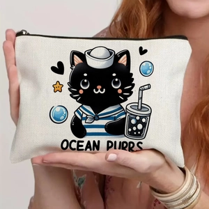 Close-up of cream canvas pouch featuring black cat sailor design and black zipper
