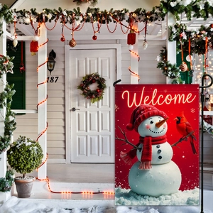 Christmas garden flag with cute snowman and cardinal bird in a festive porch setting
