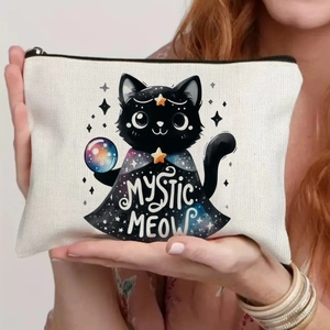 Close-up of cream canvas bag featuring a mystic black cat with a crystal ball