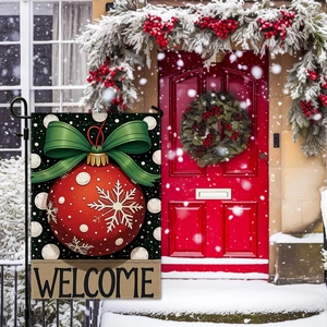 Close-up of burlap garden flag with red Christmas ball, snowflake pattern and Welcome text