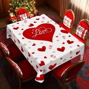Detail of white Valentine table cloth with red hearts and roses in a cozy dining setting