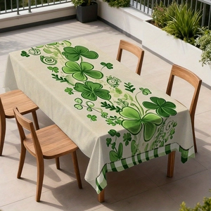 Saint Patrick's Day tablecloth with green shamrock pattern and gingham border on wood table