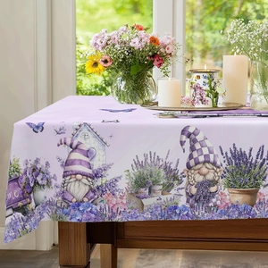 Detail of Easter tablecloth with gnomes and lavender pattern on a wooden table