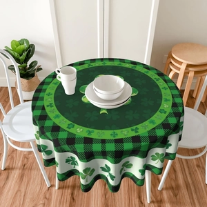 Detail of round St. Patrick's Day tablecloth with green shamrock pattern and plaid border