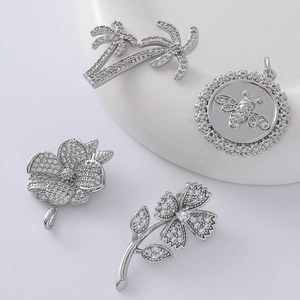 Silver flower bee and coconut tree pendants with zircon insets on ceramic base
