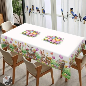 Easter tablecloth with bunnies, colorful eggs and tulips on a wooden dining table