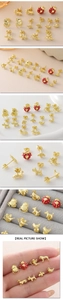 Detailed view of gold plated animal stud earrings featuring enamel bee and beetle charms