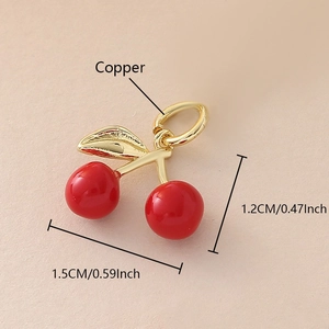 Macro detail of copper cherry pendant with red fruit and gold stem measuring 1.5cm