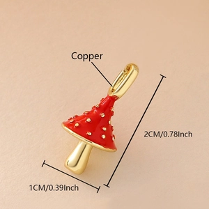 Detail of mushroom pendant in red enamel and copper with gold plating finish