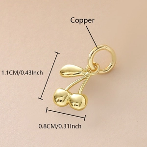 Macro detail of gold-plated copper cherry pendant with dimensions 1.1cm and zircon inlay