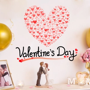 Pink heart wall decal background with romantic resin couple figurine for Valentine's Day