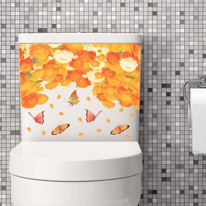 Vibrant orange floral toilet sticker with butterflies on a white ceramic tank background
