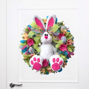 Easter bunny wreath with colorful eggs and flowers hanging on a white bedroom door