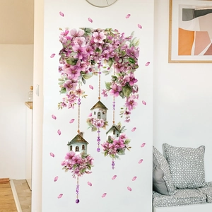 Pink floral wall stickers with birdhouses over a sofa in a modern minimalist living room