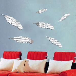 Detail view of silver feather acrylic mirror wall stickers on a blue wall decoration
