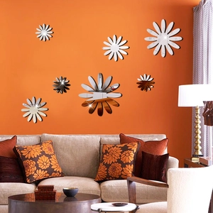 Close-up of 3D acrylic flower wall stickers with mirror effect on orange background