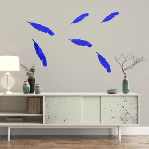 Detail of six blue acrylic feather mirror wall stickers on a modern grey background