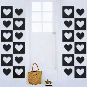 Symmetric wall decor featuring black 3D heart-shaped mirror stickers in home hallway
