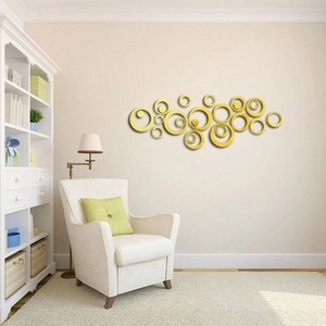 Macro detail of gold acrylic circle mirror wall stickers in a modern living room setup