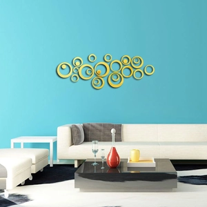 Detail of DIY acrylic mirror wall stickers in golden circles on a modern blue living room wall