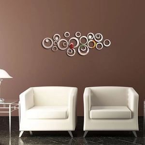 Detailed view of silver acrylic circle mirror wall stickers in a modern living room setup