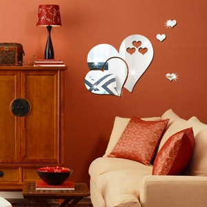 Silver acrylic heart mirror wall stickers set shown on a warm living room wall decor